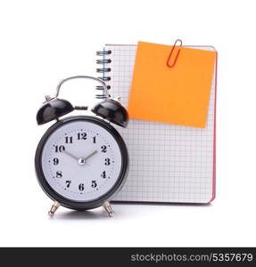 Alarm clock and blank notebook sheet. Schoolchild and student studies accessories. Back to school concept.