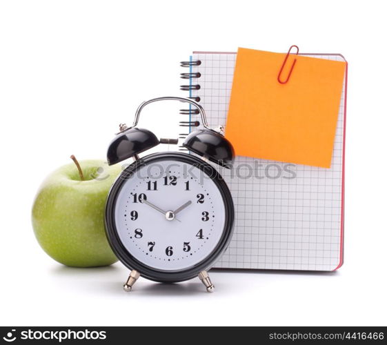 Alarm clock, blank notebook sheet and apple. Schoolchild and student studies accessories. Back to school concept.