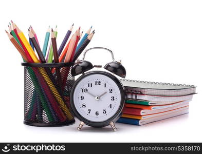 Alarm clock, notebook stack and pencils. Schoolchild and student studies accessories. Back to school concept.