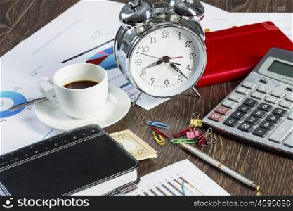 Alarm clock notepad and calculator lying on table