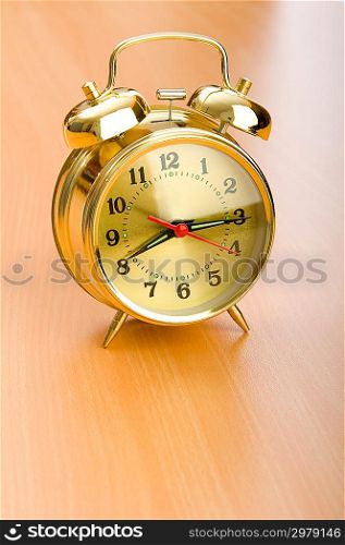 Alarm clock on the wooden table