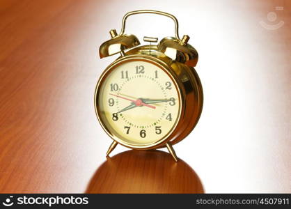 Alarm clock on the wooden table