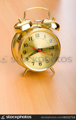 Alarm clock on the wooden table