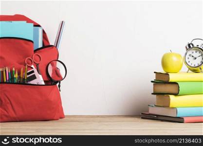 alarm clock stack books well packed school backpack with supplies