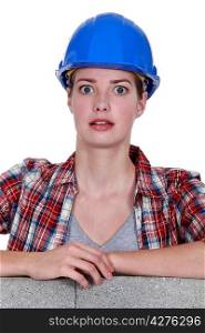 Alarmed female construction worker