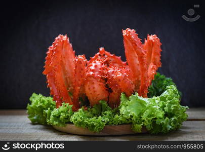 Alaskan King Crab Cooked steam or Boiled seafood and lettuce salad vegetable with dark background / red crab hokkaido