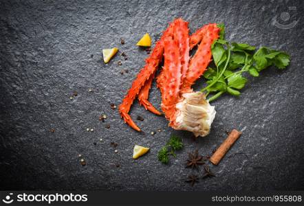 Alaskan King Crab Legs Cooked with lemon parsley herbs and spices on dark background / red crab hokkaido seafood