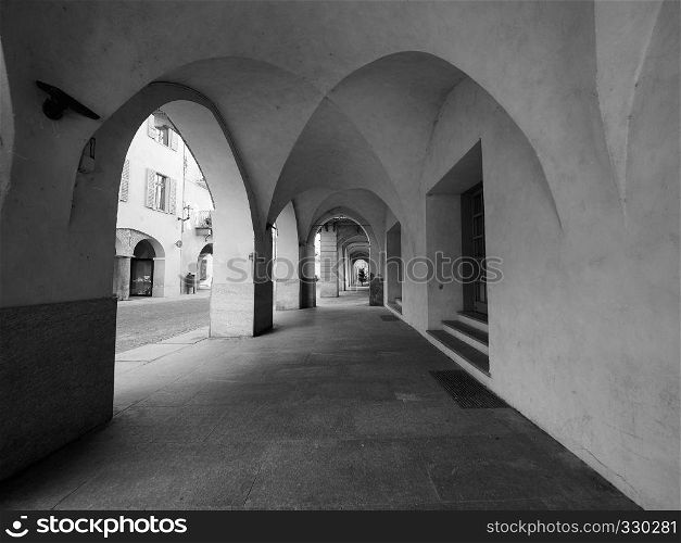 ALBA, ITALY - CIRCA FEBRUARY 2019: Colonnade portico in the old city centre in black and white. colonnade in Alba in black and white