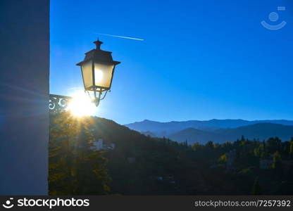 Albaicin sunrise streetlight in Granada Spain with Sierra Nevada mountains background