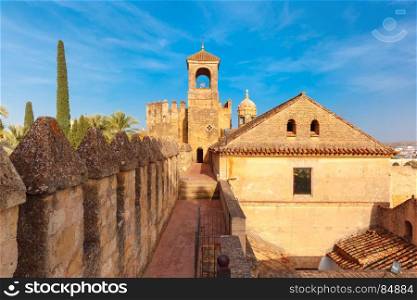 Alcazar de los Reyes Cristianos in Cordoba, Spain. Tower of Homage and North wall of Alcazar de los Reyes Cristianos or Castle of the Christian Monarchs in the sunny day, Cordoba, Andalusia, Spain