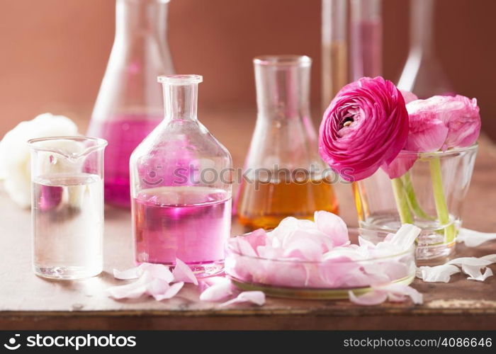 alchemy and aromatherapy set with ranunculus flowers and flasks