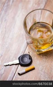 alcohol abuse, drunk driving and people concept - close up of whiskey glass and car key on table. close up of alcohol and car key on table. close up of alcohol and car key on table