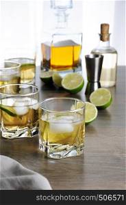 Alcohol cocktail with brandy, whiskey or rum with Ginger Ale, lime and ice in glasses