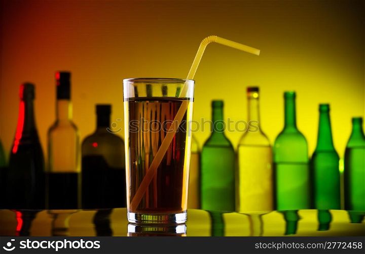 Alcohol cocktail with straw on bar