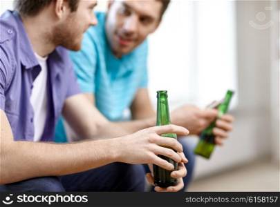 alcohol, communication, friendship, people and leisure concept - close up of male friends drinking beer at home