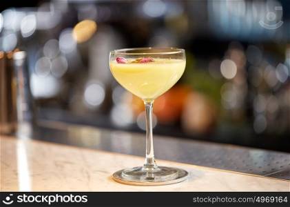 alcohol drinks and luxury concept - glass of cocktail at bar or restaurant. glass of cocktail at bar or restaurant