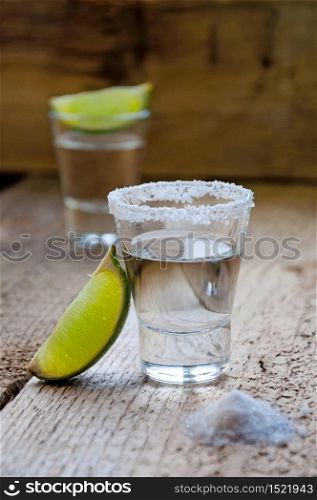Alcohol Shot Drink. Silver Tequila with Lime and Salt on the Wooden Table.. Alcohol Shot Drink. Silver Tequila with Lime and Salt on the Wooden Table
