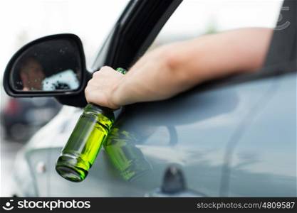 alcohol, vehicle and people concept - close up of man drinking beer while driving car