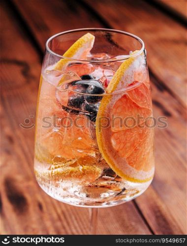 Alcoholic cocktail with grapefruit, soda, ice and gin