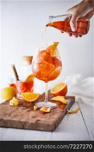 Alcoholic cocktail with orange peel and ice.