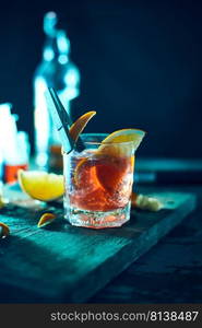 Alcoholic cocktail with orange peel and ice. 