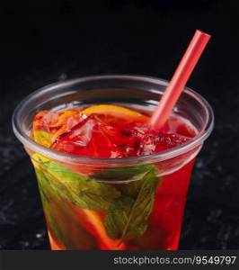 Alcoholic red fruit cocktail with a mint in leaf