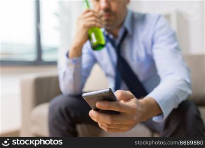 alcoholism, alcohol addiction and people concept - close up of man with smartphone drinking beer. close up of man with smartphone and alcohol bottle. close up of man with smartphone and alcohol bottle