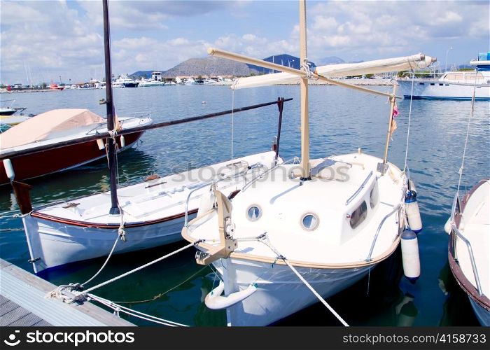 Alcudia Majorca port with llaut boats in marina on Mallorca island from Balearic Spain