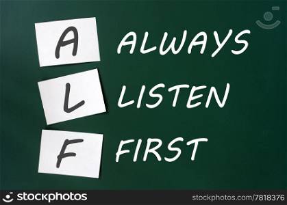ALF acronym for Always Listen First on a green board