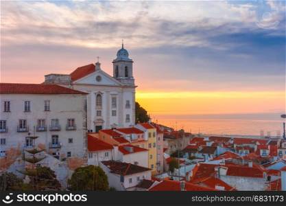Alfama at cloudy sunrise, Lisbon, Portugal. View of Alfama, the oldest district of the Old Town, with Church of Saint Stephen at cloudy sunrise, Lisbon, Portugal