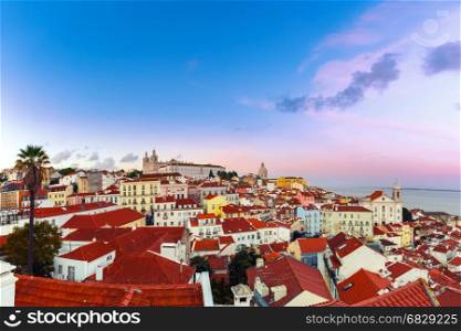 Alfama at night, Lisbon, Portugal. Panoramic view of Alfama, the oldest district of the Old Town, with Monastery of Sao Vicente de Fora, Church of Saint Stephen and National Pantheon dat sunset, Lisbon, Portugal