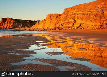Algarve rocky ocean coast at sunset. Sugres, Portugal