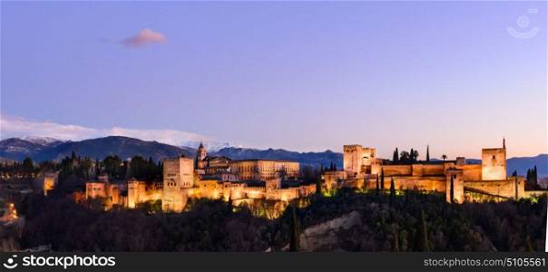 Alhambra fortress night view. Alhambra fortress night view against Sierra Nevada mountains, Granada, Spain