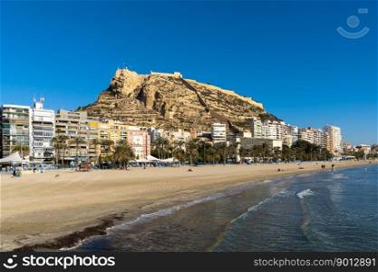Alicante, Spain - 2 February, 2023: view of Postiguet Beach and Santa Barbara Castle in downtown Alicante