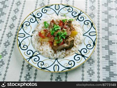 Alinazik kebab - home-style Turkish dish . topped cubes of sauteed lamb, served with rice pilaf.
