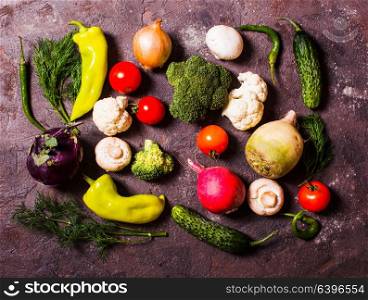 All fresh vegetables in a large set laid out on the table, top view close-up. Many vegetables laid out on the table