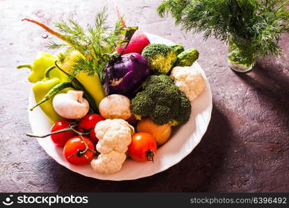 All fresh vegetables in a plate with dill. Many vegetables in plate