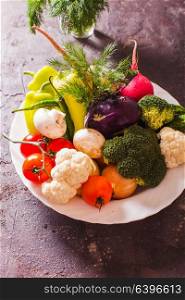 All fresh vegetables in a plate with dill. Many vegetables in plate