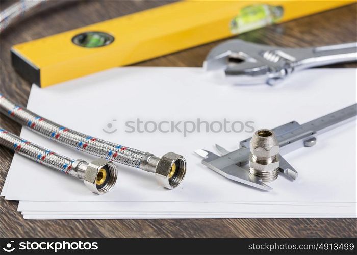 All kinds of plumbing and tools on sheet of paper