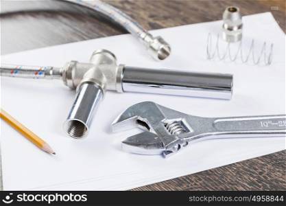 All kinds of plumbing and tools on white paper