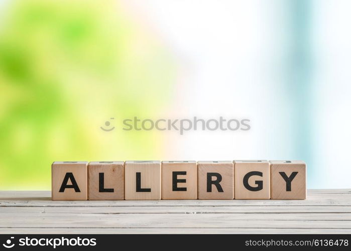 Allergy message sign on a wooden table