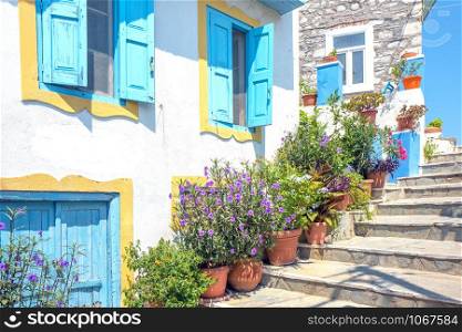 Alley with steps and flower pots in the center of Kokkari in Samos, Greece.
