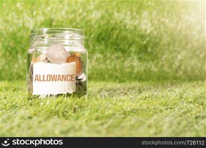 allowance money, coins in glass jar for money saving financial concept