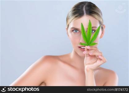 Alluring beautiful woman model portrait holding green leaf as concept for cannabis skincare cosmetic product for skin freshness treatment in isolated background.. Alluring beautiful woman portrait hold green leaf as cannabis skincare concept.