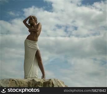 Alluring blond lady over the sky background
