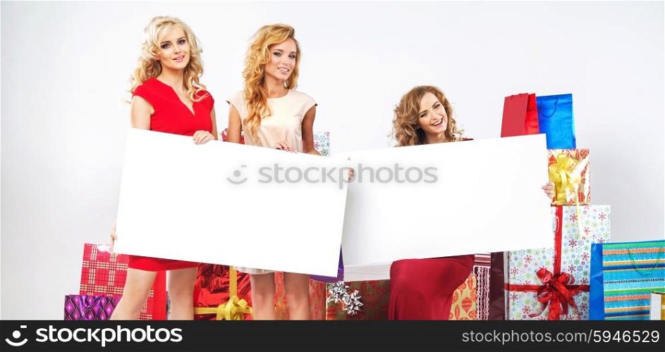 Alluring ladies holding white billboard