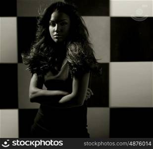 Alluring lady over the chessboard background