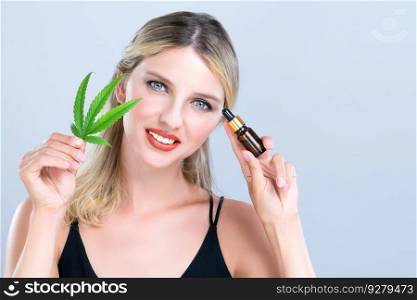 Alluring portrait of beautiful woman with perfect makeup hold green leaf, marijuan extracted bottle for skincare treatment product. Cannabis CBD oil for cosmetic and beauty in isolated background.. Alluring portrait of beautiful woman holding green leaf with CBD oil bottle.