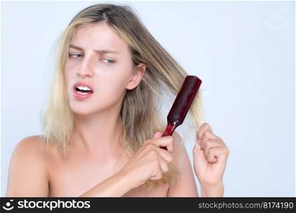 Alluring portrait of beauty cosmetic clean skin woman having brittle dry hair problem. Grimacing frustrated sad facial expression in isolated background. Damaged and hair loss concept.. Alluring portrait of woman with cosmetic skin having hair problem.