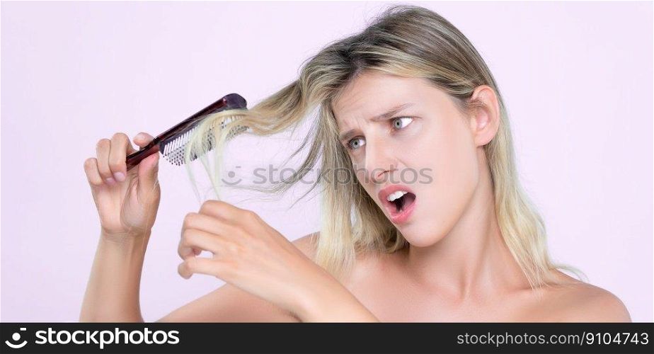 Alluring portrait of beauty cosmetic clean skin woman having brittle dry hair problem. Grimacing frustrated sad facial expression in pink isolated background. Damaged and hair loss concept.. Alluring portrait of woman with cosmetic skin having hair problem.